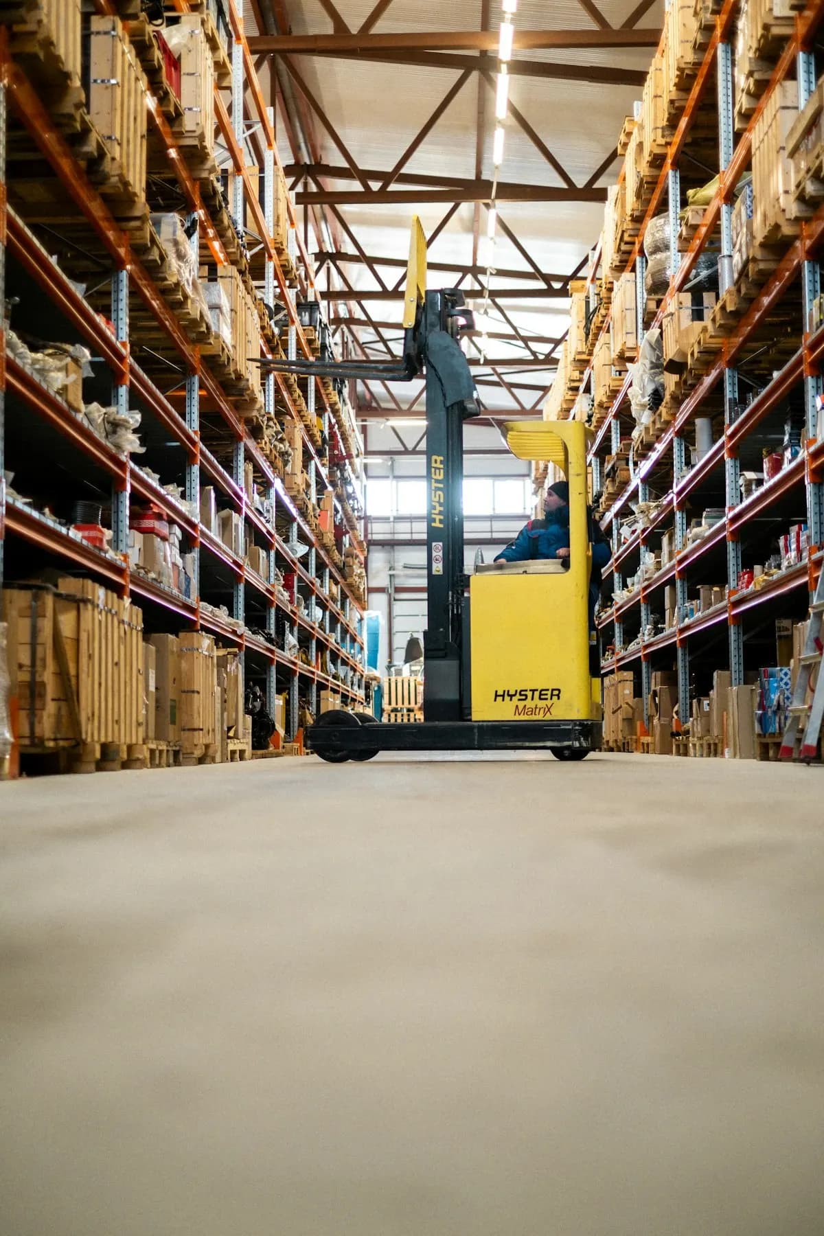 Low view of a polished concrete warehouse floor between racks