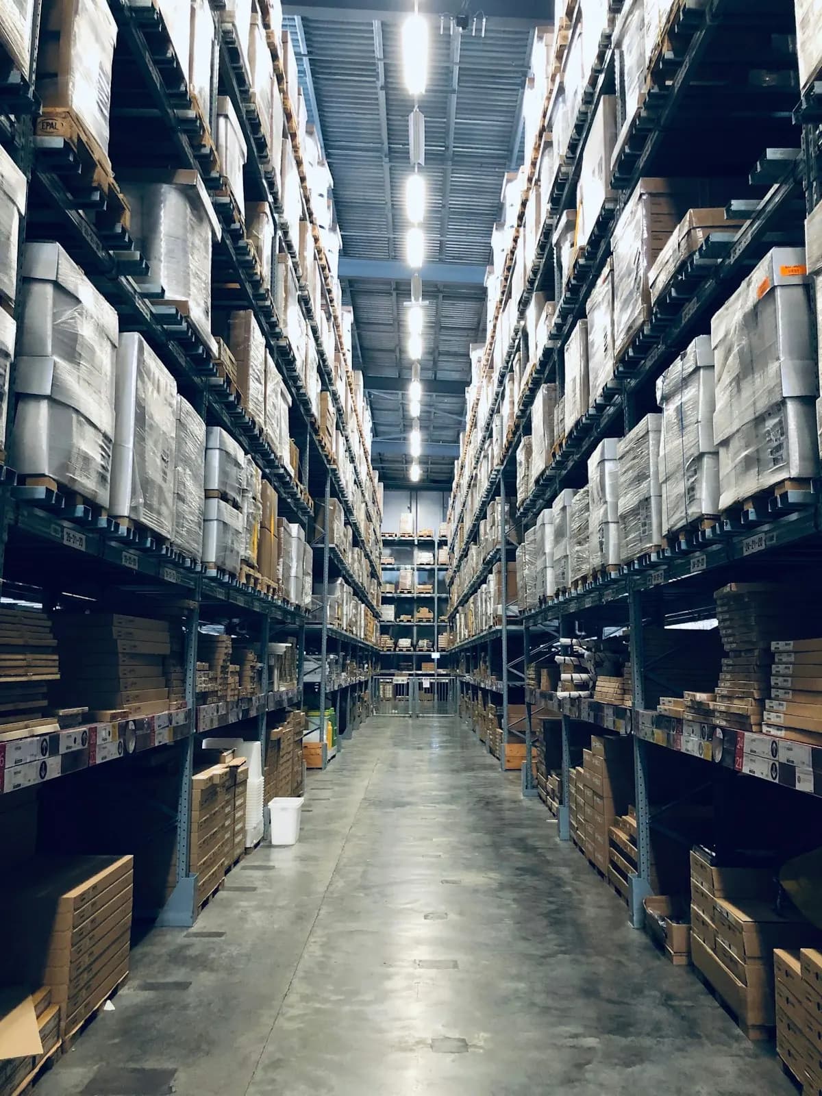 Long warehouse aisle with a smooth floor and tall racks