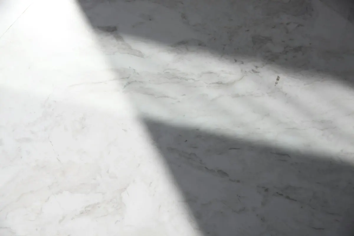 Sunlight across a smooth grey concrete floor